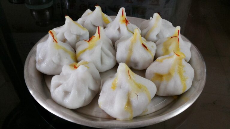 Steamed modak sweets on a plate, a traditional offering for Ganesh Chaturthi