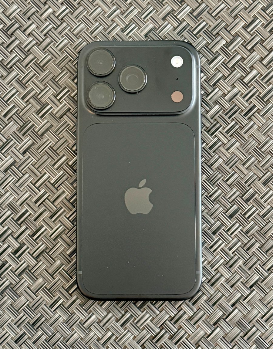Back of a black iPhone 18 Pro showing the triple camera and glass panel